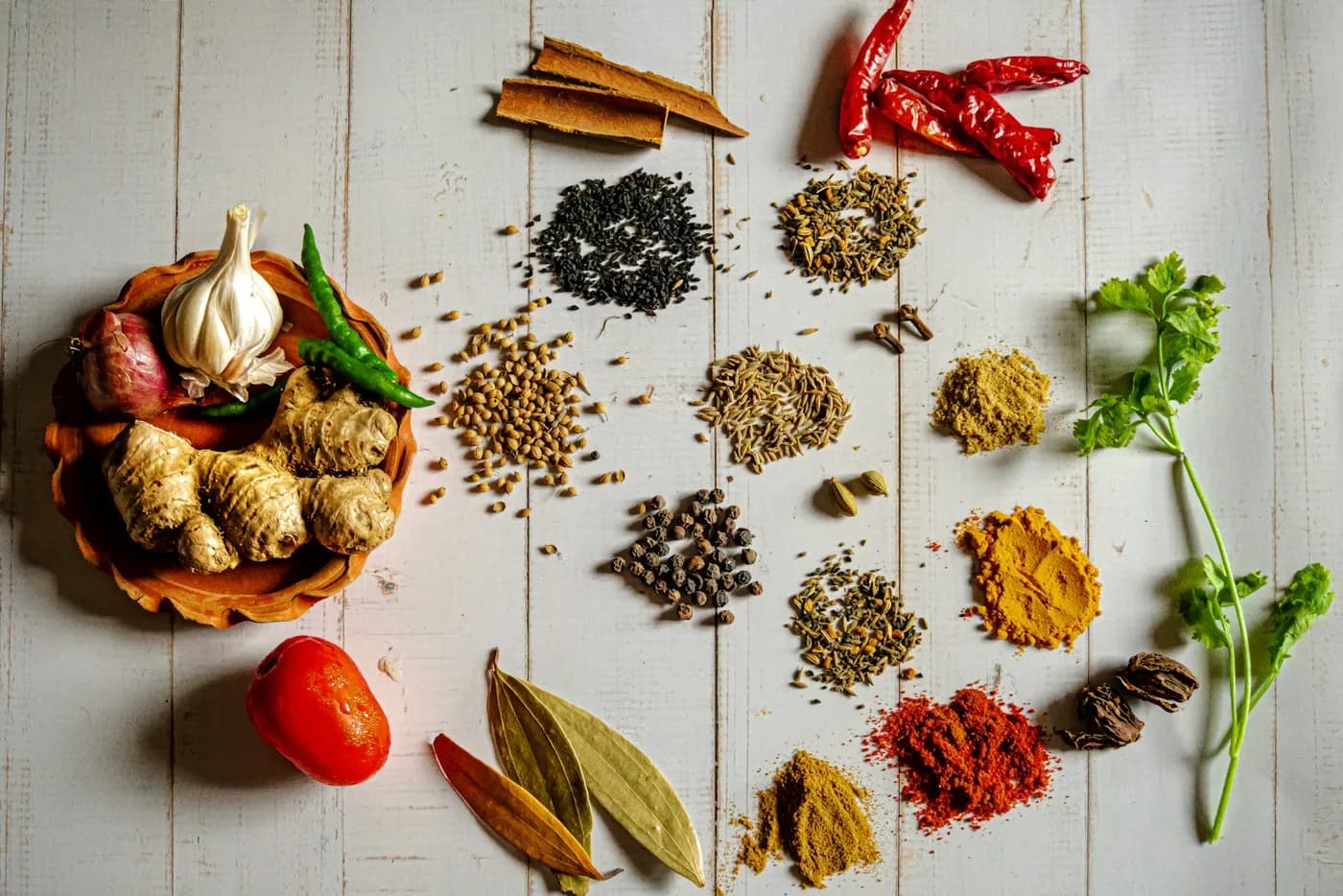 African spices, chillies, ginger and garlic laid out on a table
